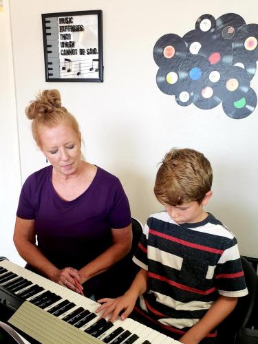 Jenny Rogers with Student at Piano
