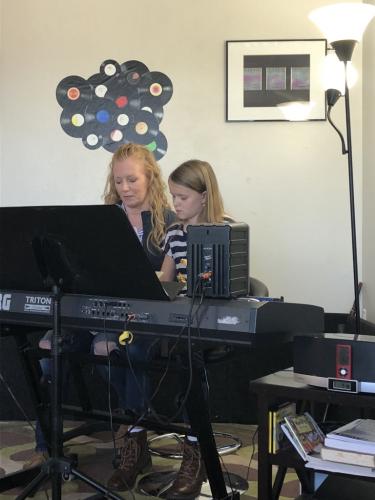 Jenny Rogers with student studying the piano